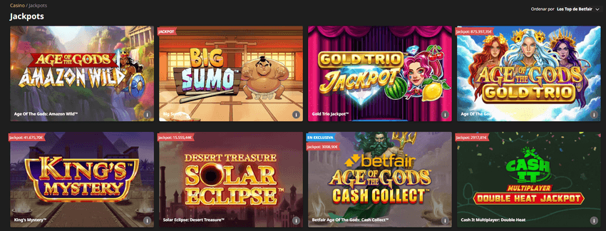 Captura de pantalla de la interfaz de juegos de jackpot de Betfair mostrando títulos populares como Age of the Gods Gold Trio o King's Mystery.