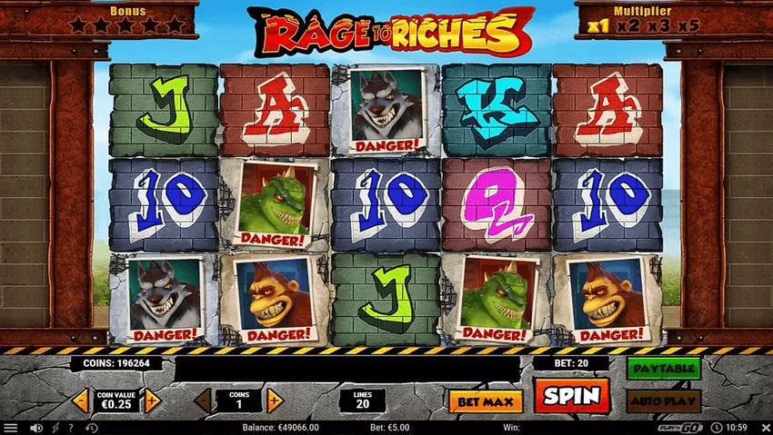 Rage to Riches – στιγμιότυπο παιχνιδιού Στιγμιότυπο του Rage to Riches με τέρατα, σύμβολα γκράφιτι και πέντε κυλίνδρους