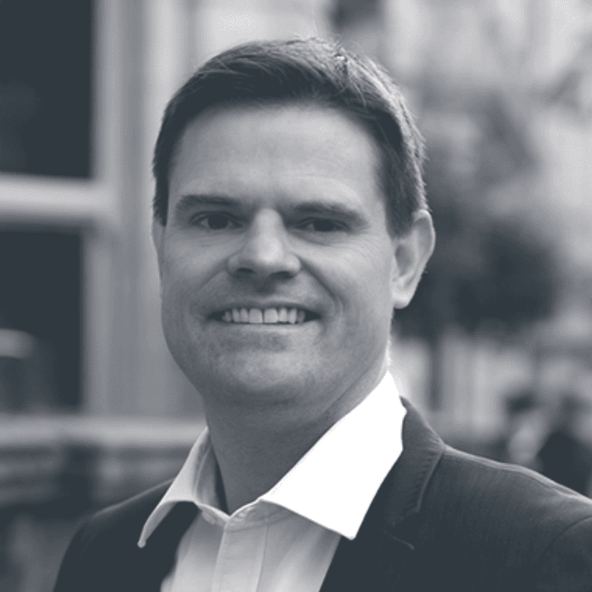 Portrait of Garry Follis, Chief Strategy Officer of the UK Betting and Gaming Council, wearing a dark suit and white shirt, smiling at the camera.